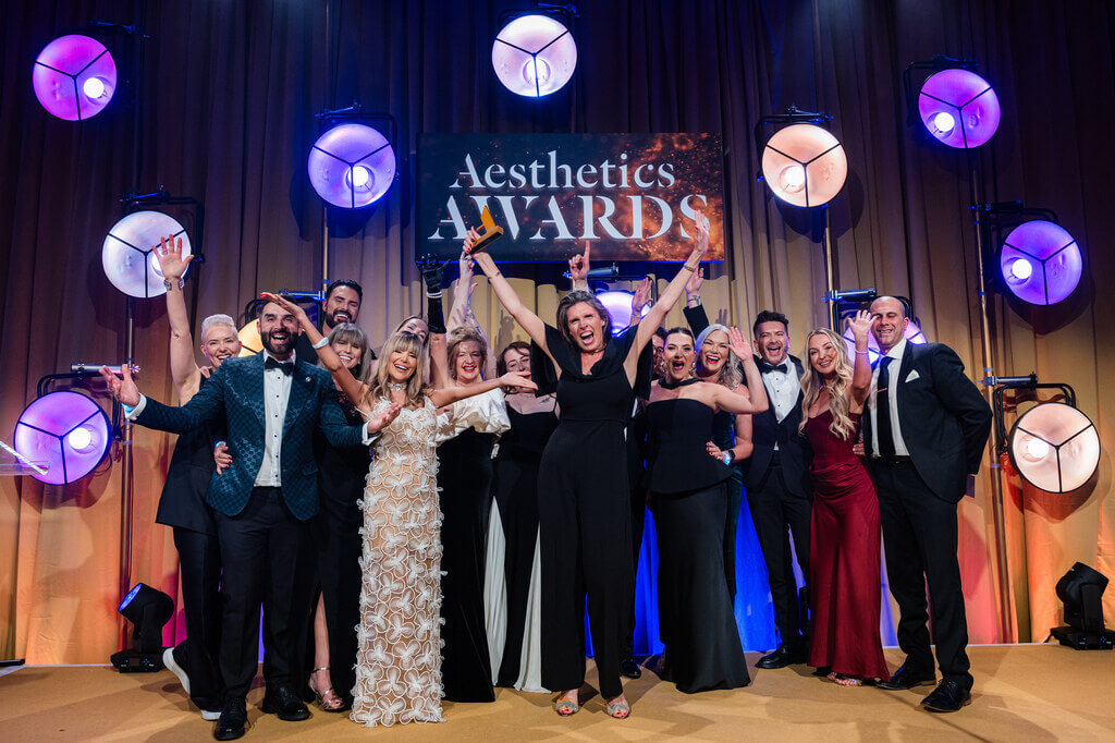 Winners of the aesthetics awards 2026 pose together on stage for a group photo.