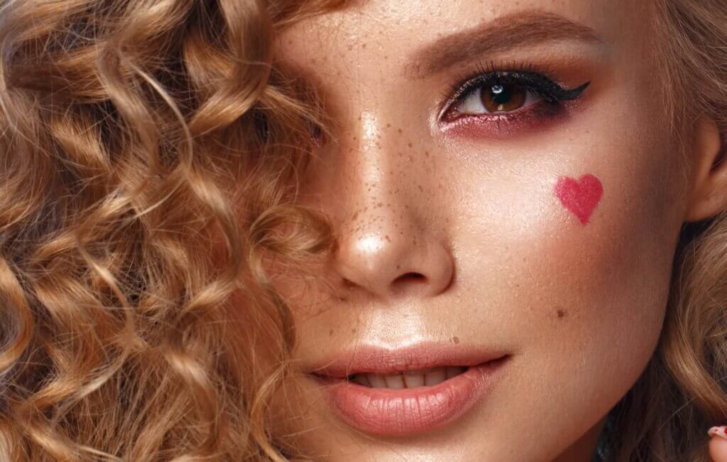 Beautiful curly haired woman with smokey eye makeup