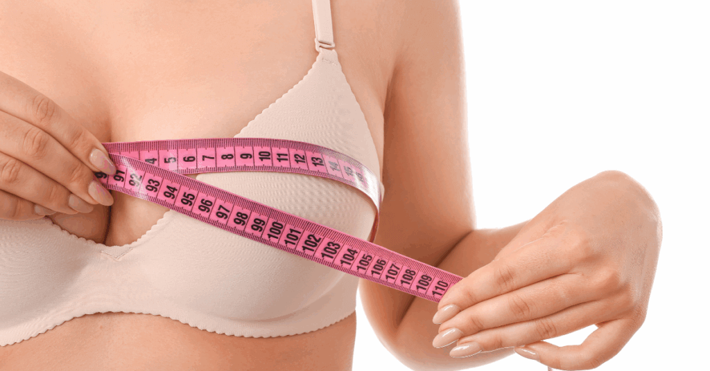 An image of a women measuring her chest for an article on Breast Augmentation