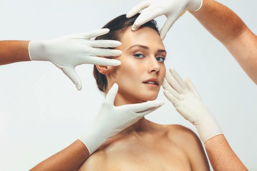 Brunette woman with hands touching face
