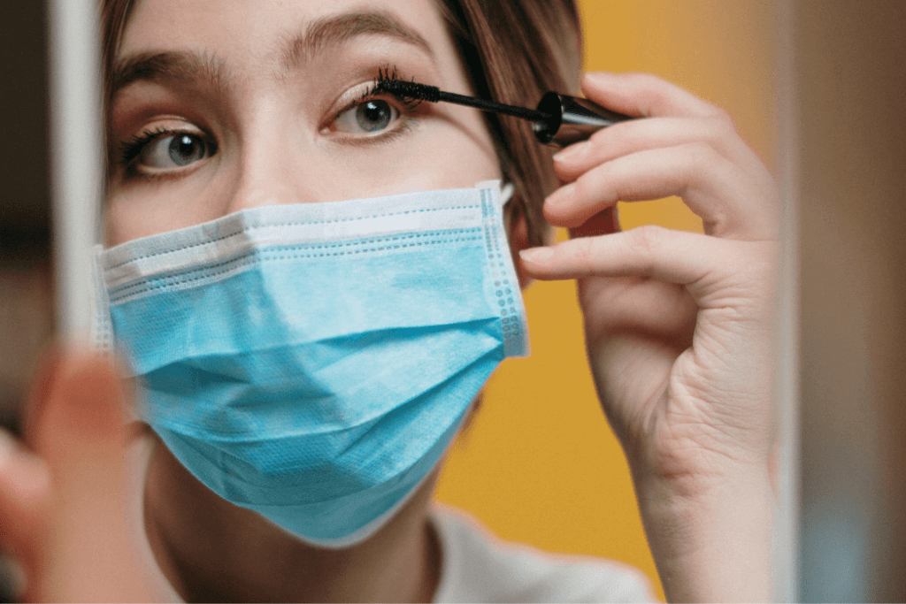 GEN C Woman doing eyelashes wearing face mask