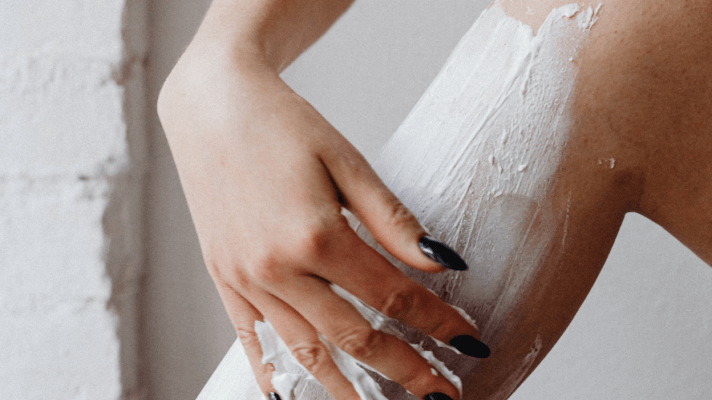 image of a woman applying nappy cream to soothe a shaving rash
