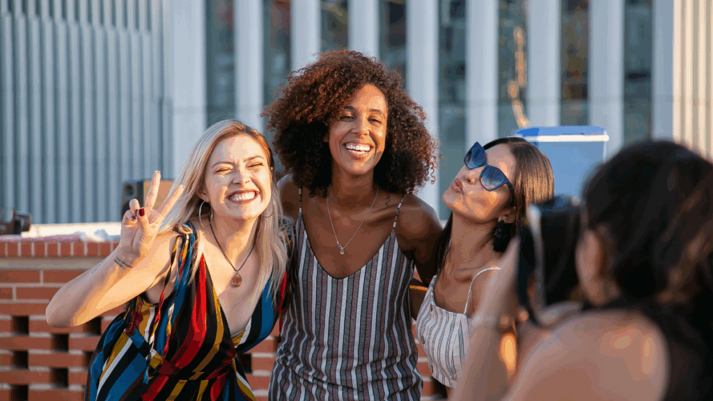 An image of three women posing for a photo outside an event for the article about The Aesthetic Show in Las Vegas