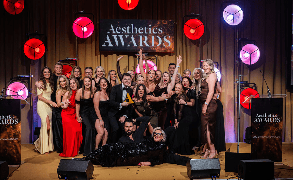 A diverse group of individuals poses for a photo at the 2026 Aesthetic Awards, celebrating their achievements in aesthetics.