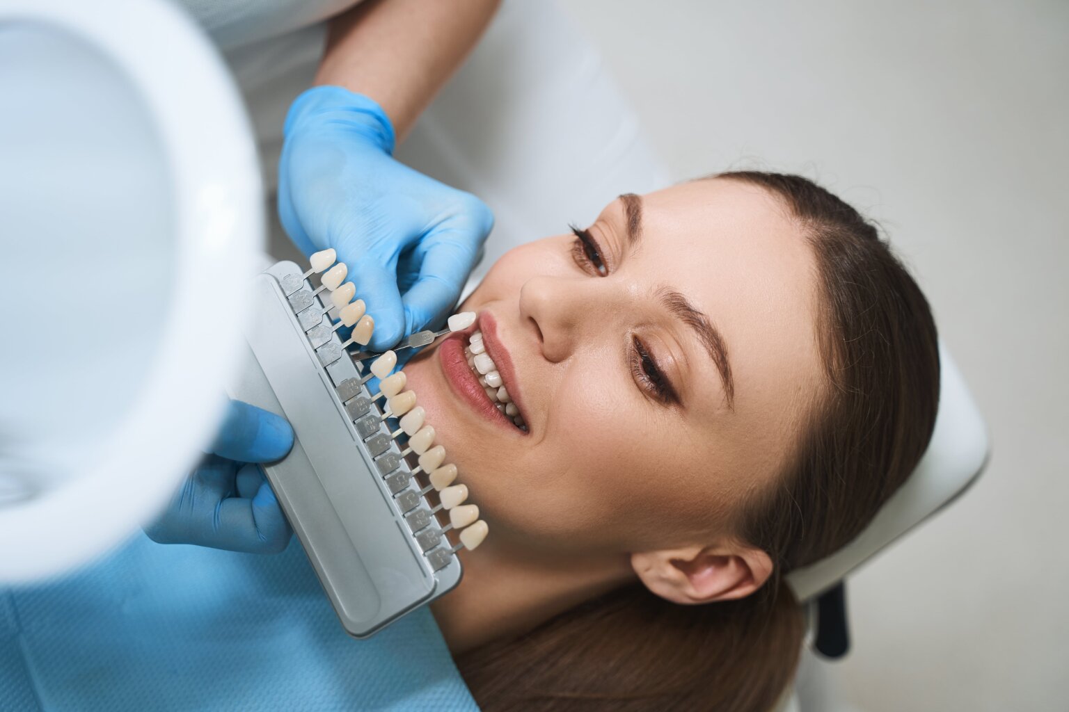 Woman receiving veneers to removed gapped teeth
