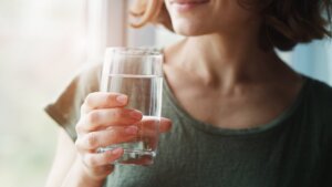 woman holding glass of water
