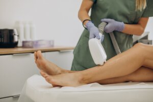 Woman receiving laser hair removal on legs