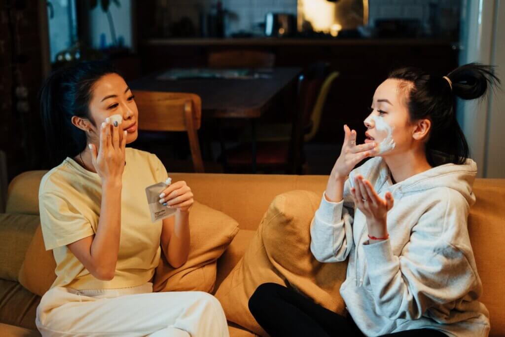 Women applying facial products to skin