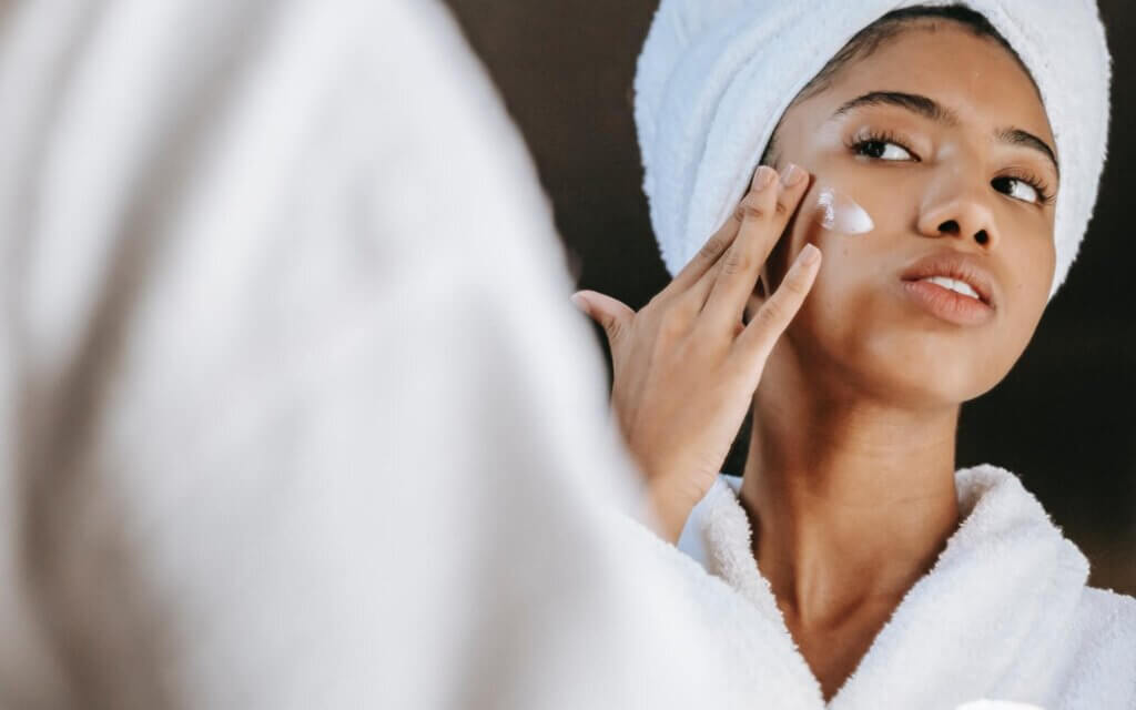Woman applyinf anti-ageing cream to face