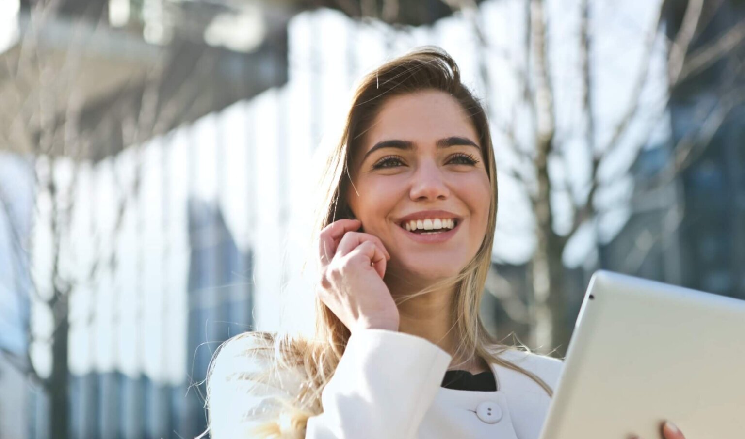 Business women, in white suit, on phone