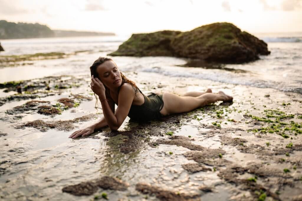 Woman on beach with seaweed
