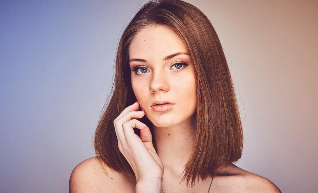 Brunette women showing off clear skin