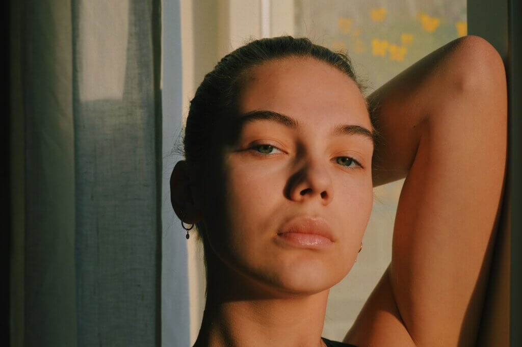 Woman showing off clear skin after using dermaroller