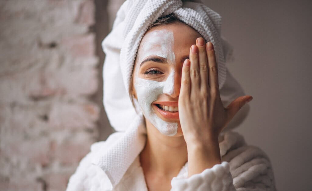Woman smiling with skincare mask on