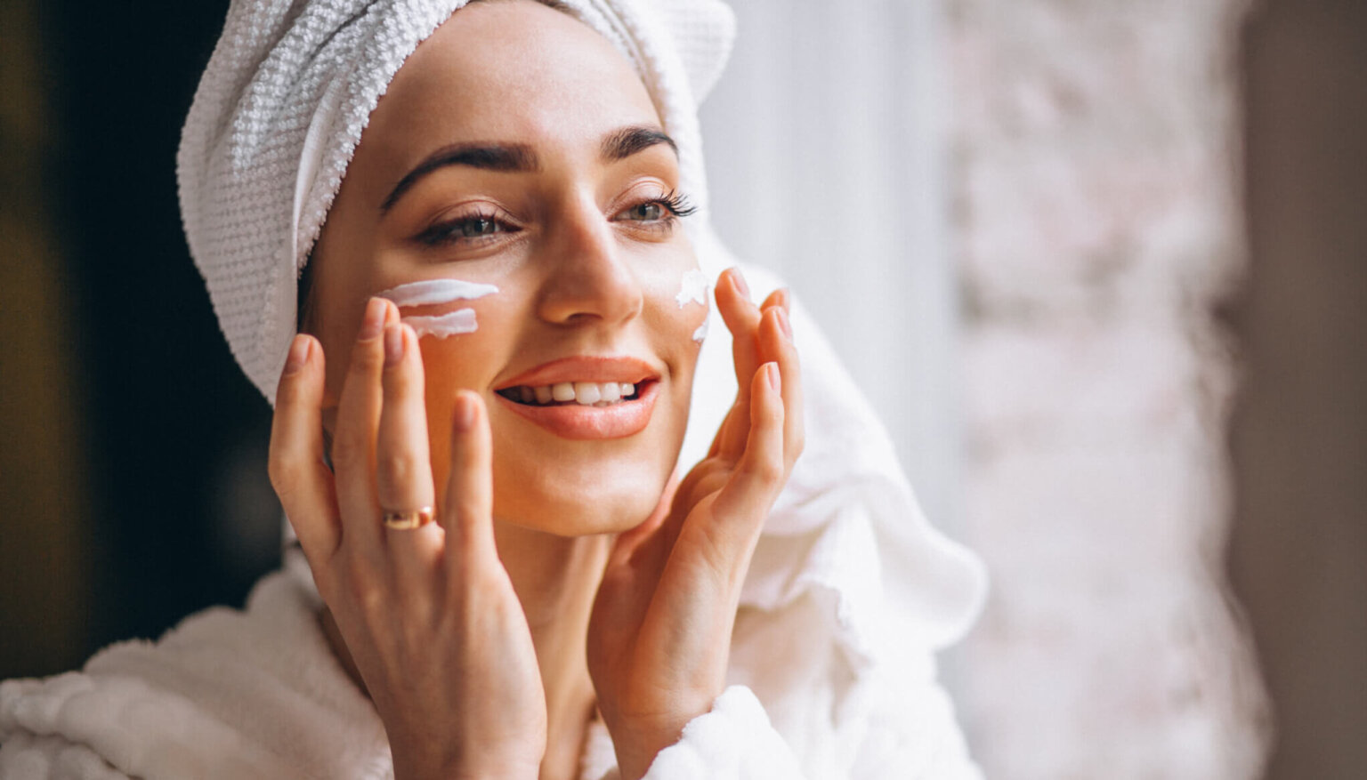 Woman applying face cream