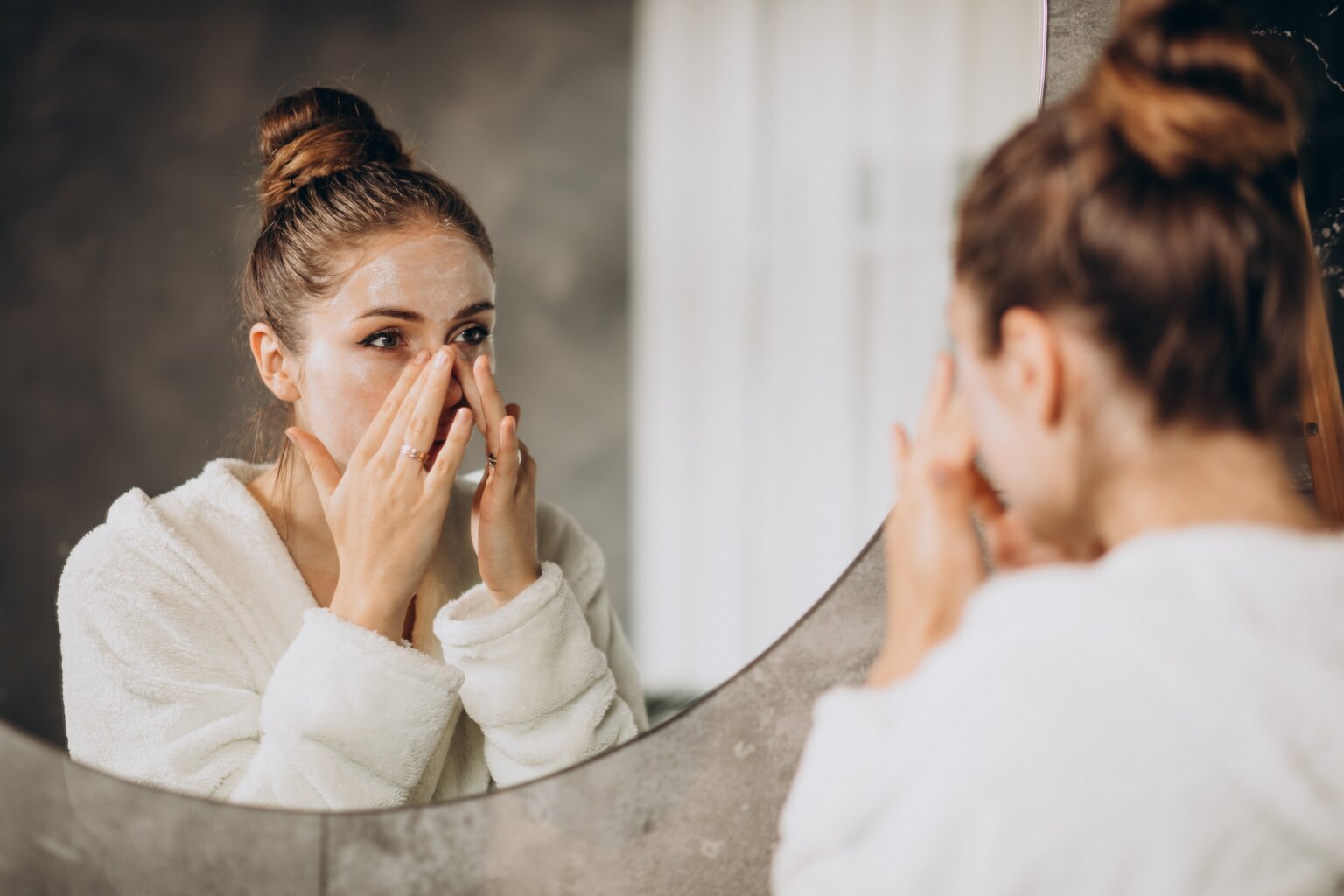 woman washing face in bathroom