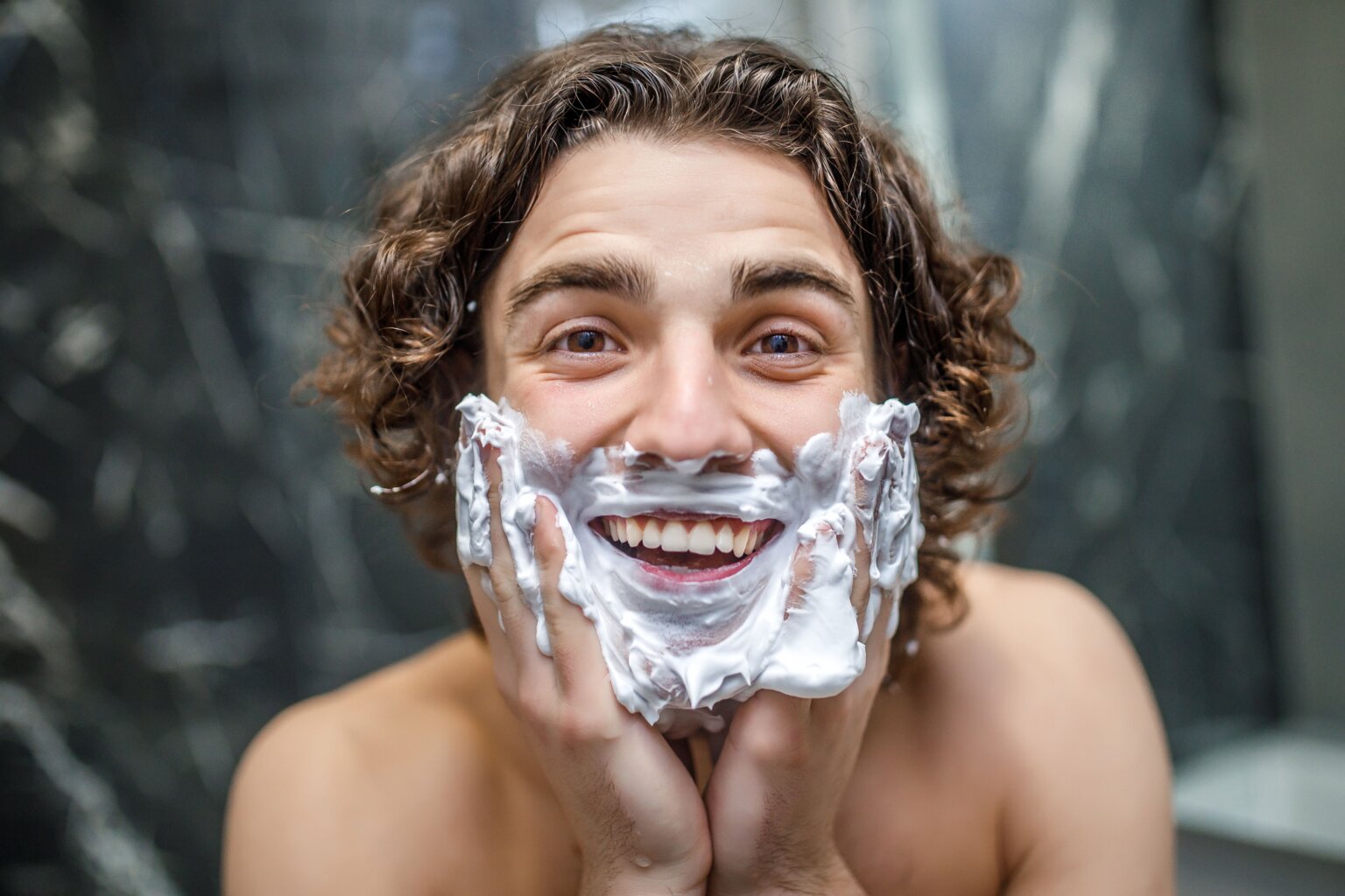 Man applying shaving lotion to his face