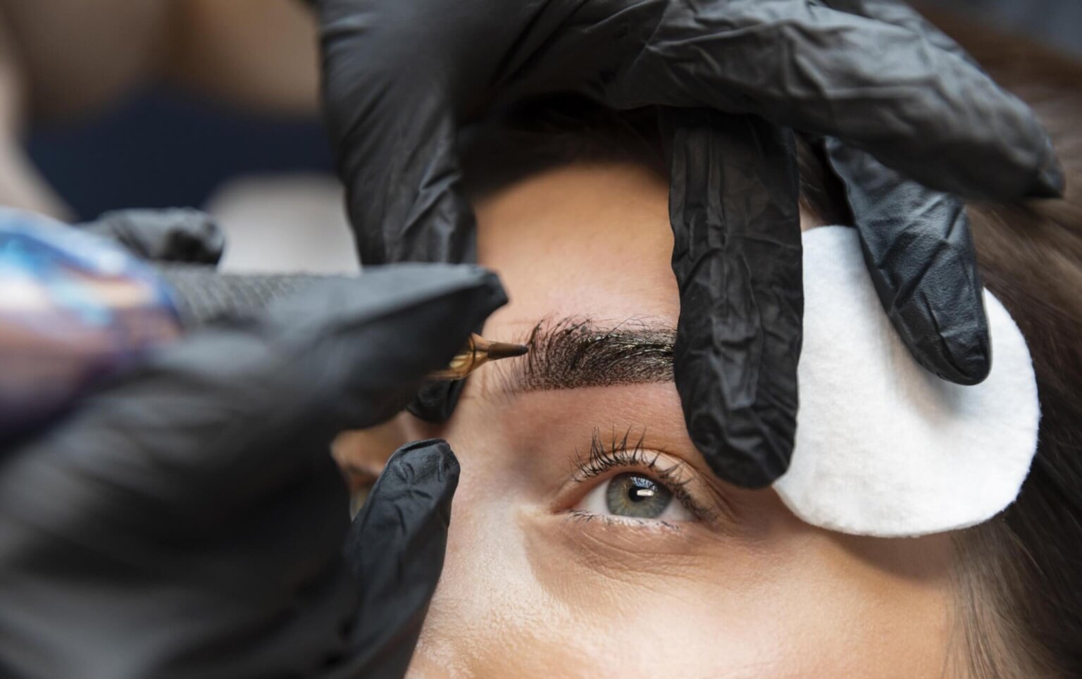 Woman having microblading treatment